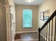 Welcoming foyer with hardwood floors, staircase, window with blinds, and decorative wall art at 2311 Verde Creek Rd, Charlotte, NC 28214