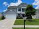 Charming two-story home featuring a two-car garage, well-maintained lawn, and an inviting front porch at 2311 Verde Creek Rd, Charlotte, NC 28214