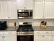 Modern kitchen featuring stainless steel appliances, granite countertops, and white cabinets at 2311 Verde Creek Rd, Charlotte, NC 28214