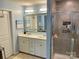 Well-lit main bathroom featuring a dual sink vanity and tiled shower at 2311 Verde Creek Rd, Charlotte, NC 28214