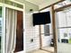 Exterior of screened in porch featuring TV and view of home's siding and back entrance at 2311 Verde Creek Rd, Charlotte, NC 28214
