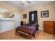 Cozy bedroom with a comfortable bed, dresser, and a window with dark curtains at 3 Circle Dr, Lincolnton, NC 28092