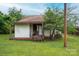 Exterior view featuring a small home with a covered back porch and a grassy front yard at 3 Circle Dr, Lincolnton, NC 28092
