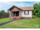 Inviting one-story home featuring a classic porch and a lush, green front yard at 3 Circle Dr, Lincolnton, NC 28092