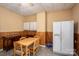 Simple kitchen with a dining table, white refrigerator, ample cabinet space, and linoleum flooring at 3 Circle Dr, Lincolnton, NC 28092