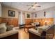 Comfortable living room with wood paneling, ceiling fan and neutral colored furniture set at 3 Circle Dr, Lincolnton, NC 28092