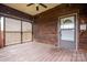 Welcoming covered porch with lattice details, wood flooring, and a classic ceiling fan at 3 Circle Dr, Lincolnton, NC 28092