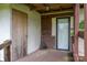 Covered porch entrance featuring weathered wood, a storage closet, and a white screen door at 3 Circle Dr, Lincolnton, NC 28092
