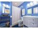 Bright blue bathroom featuring a single sink vanity, a shower-tub combo, and updated fixtures at 3017 Brooks Mill Ln # 10, Wingate, NC 28174