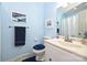 Charming light blue bathroom featuring a vanity with sink, toilet, and nautical-themed decor at 3017 Brooks Mill Ln # 10, Wingate, NC 28174