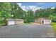 Property featuring a detached garage and an attached garage with ample parking on a gravel driveway at 3017 Brooks Mill Ln # 10, Wingate, NC 28174