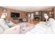 Inviting living room featuring wood-paneled walls, fireplace, and plush white seating at 3017 Brooks Mill Ln # 10, Wingate, NC 28174