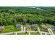Expansive aerial view featuring well-kept properties nestled amongst a vibrant, green wooded area and lake view at 319 S San Agustin Dr, Mooresville, NC 28117