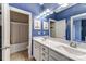 Bright blue bathroom with double sink vanity, framed art, and a shower-tub combo at 319 S San Agustin Dr, Mooresville, NC 28117