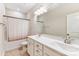 Clean, bright bathroom features a double vanity, shower-tub combo with modern fixtures at 319 S San Agustin Dr, Mooresville, NC 28117