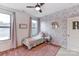 Charming bedroom featuring floral wallpaper, ample natural light, and a cozy pink rug at 319 S San Agustin Dr, Mooresville, NC 28117