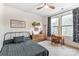 Cozy bedroom with natural light, stylish decor, and a comfortable study area at 319 S San Agustin Dr, Mooresville, NC 28117
