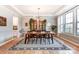 Spacious dining room featuring a large wooden table, hardwood floors, and ample natural light at 319 S San Agustin Dr, Mooresville, NC 28117