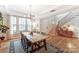 Open-concept dining room with hardwood floors, large windows, and a modern light fixture at 319 S San Agustin Dr, Mooresville, NC 28117