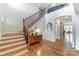 Bright foyer with hardwood floors, staircase, and decorative console table at 319 S San Agustin Dr, Mooresville, NC 28117