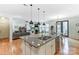 Open-concept kitchen with a large island, stainless steel appliances, and seamless flow to the living room at 319 S San Agustin Dr, Mooresville, NC 28117