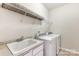 Laundry room featuring a sink, counter space, overhead shelving, and white washer and dryer at 319 S San Agustin Dr, Mooresville, NC 28117