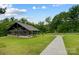 Picturesque outdoor picnic shelter with tables, a grill, and a path to a playground in a green space at 319 S San Agustin Dr, Mooresville, NC 28117