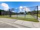 Well-maintained tennis court with basketball hoop in a fenced area ready for sports and recreation at 319 S San Agustin Dr, Mooresville, NC 28117