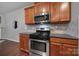 Cozy kitchen featuring stainless steel appliances, granite countertops, and stylish wood cabinets at 3342 Yarmouth Ln, Gastonia, NC 28056