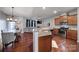 Stylish kitchen with granite counters, stainless appliances, and hardwood floors seamlessly flowing into the living area at 3342 Yarmouth Ln, Gastonia, NC 28056