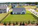An aerial view showcases a large, fenced backyard and a modern home's exterior at 3924 Dahlia Dr, Harrisburg, NC 28075