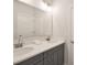 Bathroom with gray cabinets, and sinks, granite countertop and vanity mirror at 3924 Dahlia Dr, Harrisburg, NC 28075