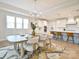 Elegant dining area with a modern chandelier, seating for six, and a view into the kitchen at 3924 Dahlia Dr, Harrisburg, NC 28075