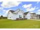 Well-maintained home boasting lush green lawn, white siding, and a convenient two-car garage at 3924 Dahlia Dr, Harrisburg, NC 28075