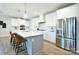Bright, open kitchen with white cabinets, stainless steel appliances, large island, and stylish pendant lighting at 3924 Dahlia Dr, Harrisburg, NC 28075
