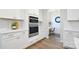 Bright kitchen with stainless steel built-in oven and microwave, subway tile backsplash, and adjacent desk nook at 3924 Dahlia Dr, Harrisburg, NC 28075