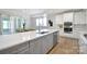 Spacious kitchen featuring a large center island, white countertops, stainless steel appliances, and open dining area at 3924 Dahlia Dr, Harrisburg, NC 28075