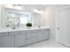 Bathroom with double vanity, gray cabinets, and large mirror, creating a serene and functional space at 3924 Dahlia Dr, Harrisburg, NC 28075