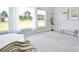 Bright bedroom featuring large windows, neutral decor, plush carpeting, and a relaxing atmosphere at 3924 Dahlia Dr, Harrisburg, NC 28075