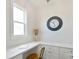 Brightly-lit office nook with built-in desk, quartz countertops, custom cabinetry, and a large window at 3924 Dahlia Dr, Harrisburg, NC 28075