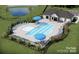 Community pool area with multiple lounge chairs and umbrellas surrounded by a fence at 3924 Dahlia Dr, Harrisburg, NC 28075