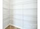 Walk-in closet features a minimalist design with open shelving, providing ample storage space at 3924 Dahlia Dr, Harrisburg, NC 28075