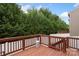 This charming back deck features wooden railings and is surrounded by lush greenery, offering privacy at 4278 Park South Station Blvd, Charlotte, NC 28210