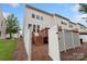 Backyard featuring a well-maintained lawn, a wooden deck, and a white fence, creating a private outdoor oasis at 4278 Park South Station Blvd, Charlotte, NC 28210