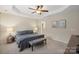 Bedroom featuring neutral carpet, ensuite bathroom access, ceiling fan, and neutral paint at 4278 Park South Station Blvd, Charlotte, NC 28210