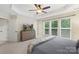 Bright bedroom features neutral carpet, three large windows, ceiling fan, and neutral walls at 4278 Park South Station Blvd, Charlotte, NC 28210