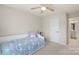 Bedroom with neutral carpet, ceiling fan, and ensuite bathroom access at 4278 Park South Station Blvd, Charlotte, NC 28210