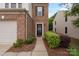 Close-up of a brick-front townhome with a one-car garage and a black front door at 4278 Park South Station Blvd, Charlotte, NC 28210