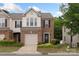 Charming brick-front townhome with a one-car garage and beautifully landscaped front yard at 4278 Park South Station Blvd, Charlotte, NC 28210