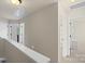 Upstairs hallway with several doors and staircase at 4278 Park South Station Blvd, Charlotte, NC 28210